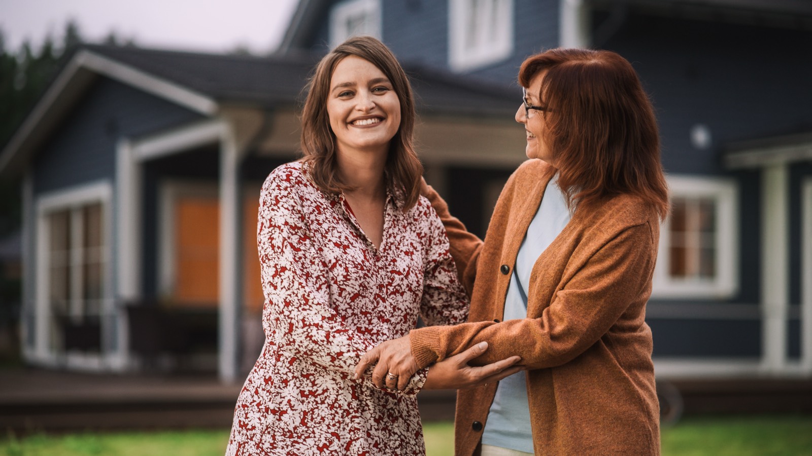 An adult daughter and her mother together at home, talking warmly